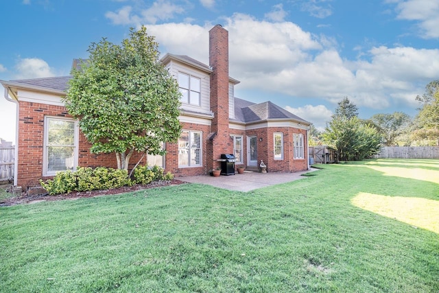 back of house with a yard and a patio area