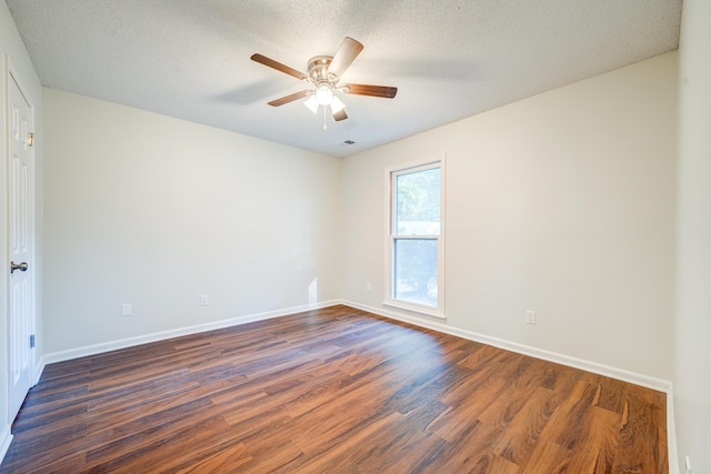 unfurnished room with a textured ceiling, ceiling fan, and dark wood-type flooring