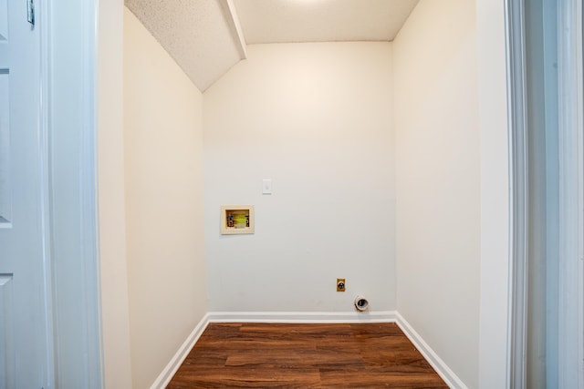 washroom featuring hookup for a washing machine, a textured ceiling, dark hardwood / wood-style flooring, and hookup for an electric dryer