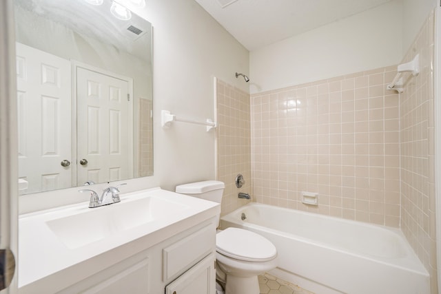 full bathroom with vanity, tiled shower / bath combo, and toilet