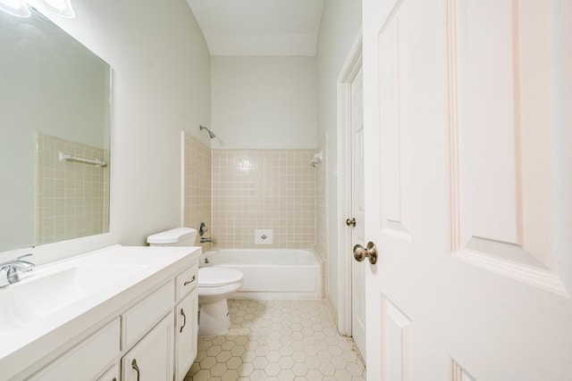 full bathroom with tiled shower / bath combo, vanity, and toilet