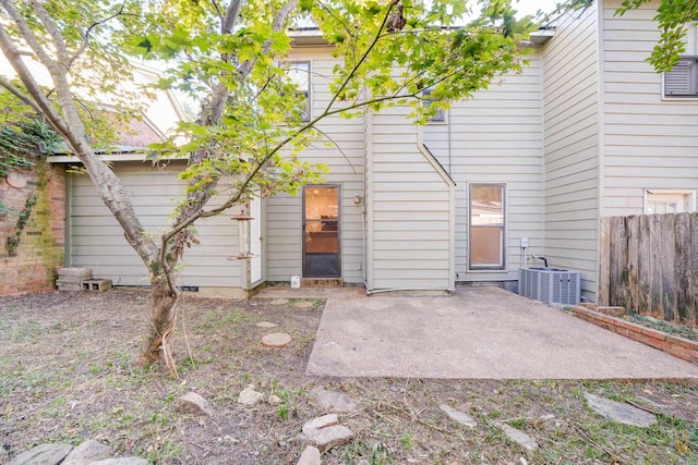 rear view of house with a patio area and central air condition unit