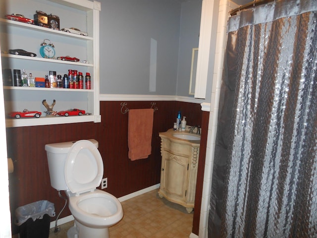 bathroom with walk in shower, vanity, and toilet