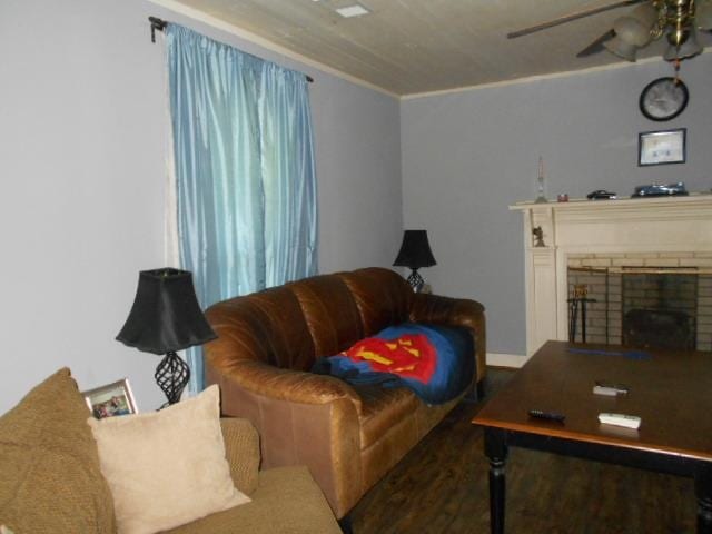 living room with crown molding, a fireplace, and ceiling fan