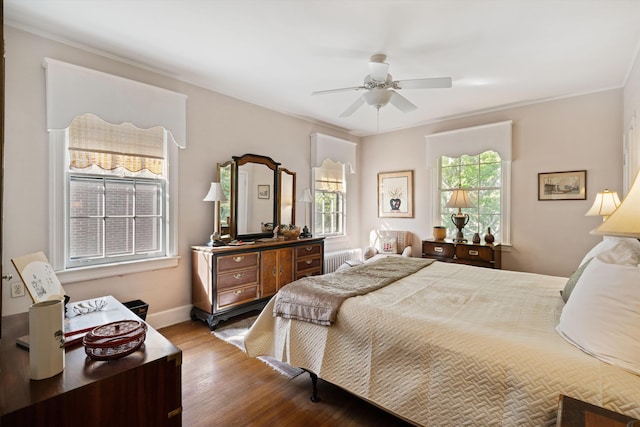 bedroom featuring ceiling fan, hardwood / wood-style floors, ornamental molding, and radiator