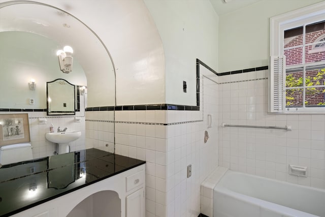 bathroom featuring sink, toilet, tile walls, and a washtub