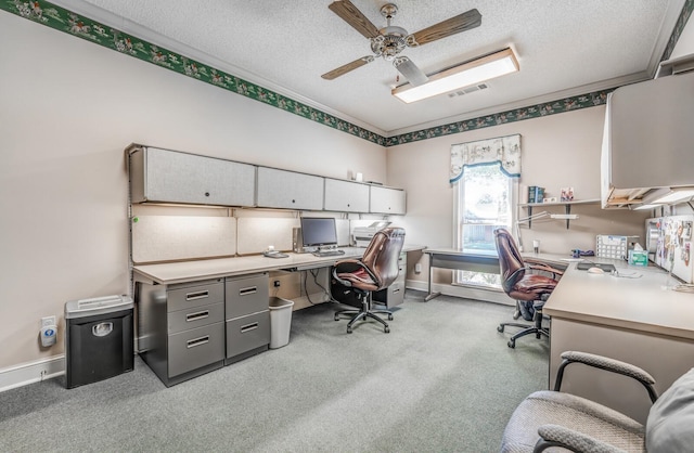 carpeted office featuring ceiling fan and a textured ceiling