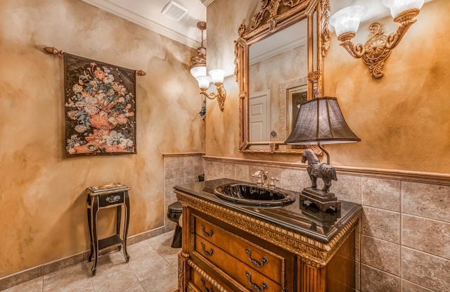 bathroom featuring ornamental molding, tile patterned flooring, and vanity