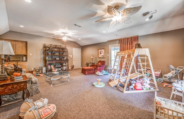 carpeted living room with ceiling fan, lofted ceiling, and a fireplace