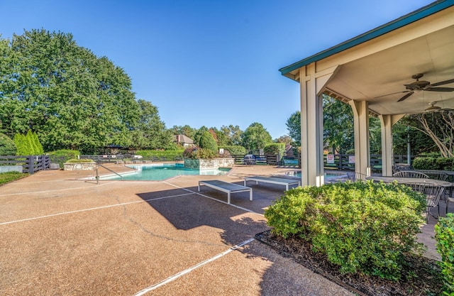 view of pool with ceiling fan, pool water feature, and a patio area