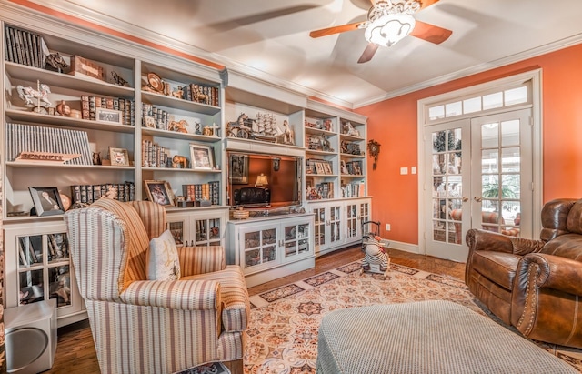 living area featuring crown molding, ceiling fan, wood-type flooring, and french doors