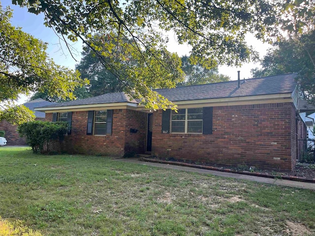 ranch-style home with a front lawn