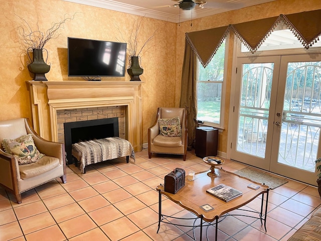 sitting room with ornamental molding, ceiling fan, french doors, and tile patterned floors