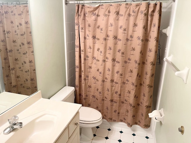 bathroom featuring walk in shower, vanity, and toilet