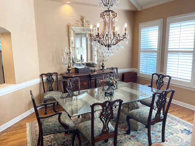 dining room featuring crown molding and light hardwood / wood-style floors