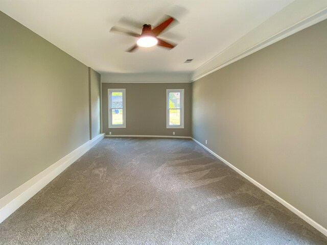 unfurnished room with crown molding, ceiling fan, and carpet flooring