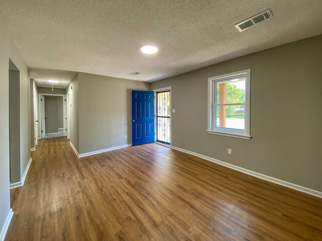 spare room with wood-type flooring and a textured ceiling