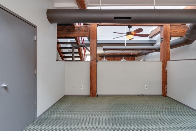 empty room featuring carpet floors and ceiling fan