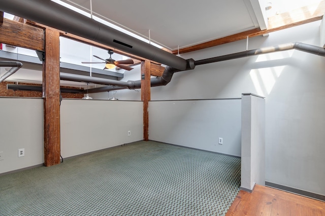 basement with carpet floors and ceiling fan