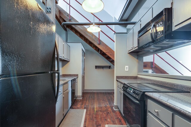 kitchen with dark wood-type flooring, white cabinets, black appliances, and a skylight