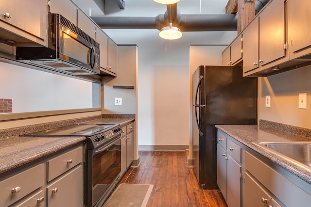 kitchen featuring gray cabinetry, dark hardwood / wood-style floors, and black appliances