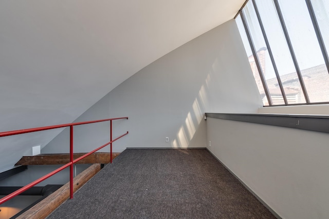 interior space with carpet floors and lofted ceiling