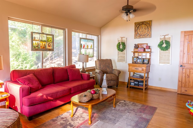 living room featuring lofted ceiling, a healthy amount of sunlight, ceiling fan, and wood-type flooring