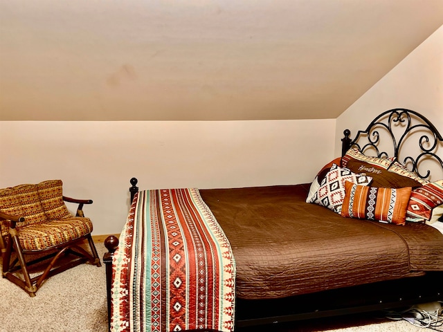 carpeted bedroom featuring vaulted ceiling