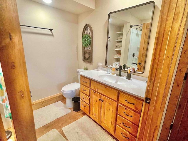 bathroom with walk in shower, vanity, and toilet