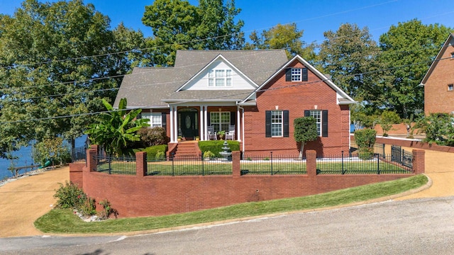 view of front of property featuring brick siding, a front lawn, and a fenced front yard