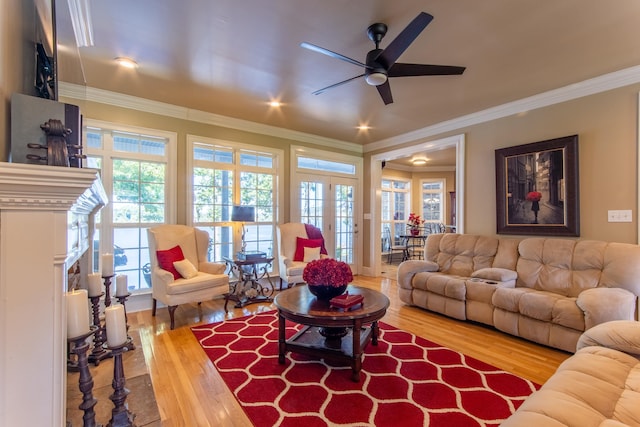 living room with ornamental molding, hardwood / wood-style flooring, and ceiling fan