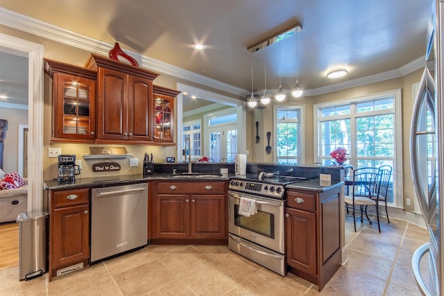 kitchen featuring dark stone countertops, ornamental molding, stainless steel appliances, and sink