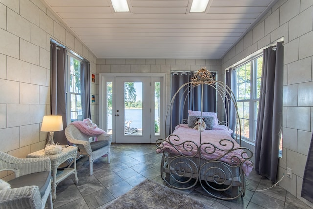 bedroom with wood ceiling and access to outside