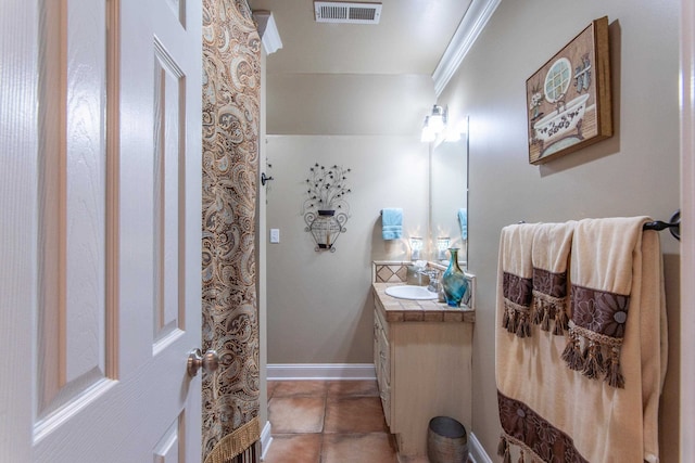 bathroom with vanity, crown molding, and tile patterned floors