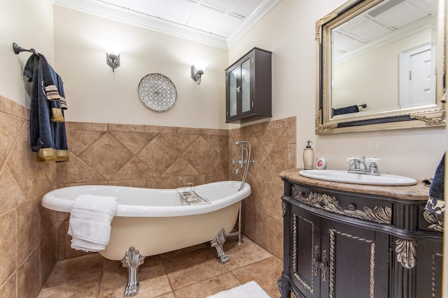 bathroom with crown molding, a washtub, tile patterned floors, tile walls, and vanity