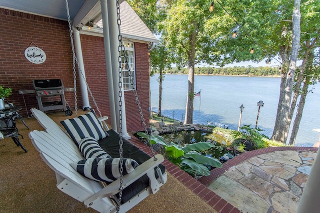 view of patio with a water view and grilling area