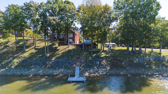 exterior space with a water view and a dock