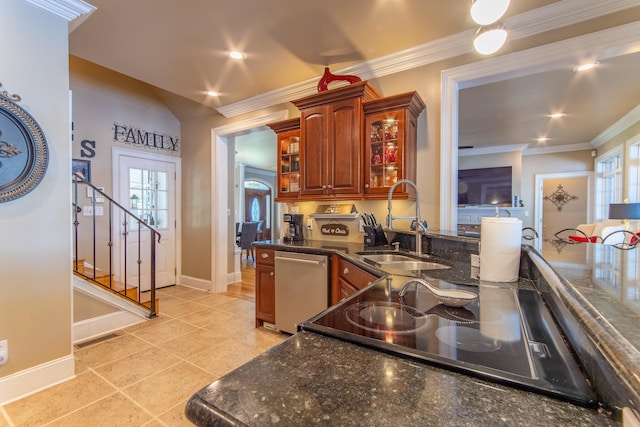 kitchen featuring dark stone countertops, crown molding, sink, and stainless steel dishwasher