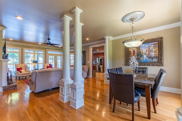 dining area featuring ceiling fan, ornamental molding, ornate columns, and hardwood / wood-style floors