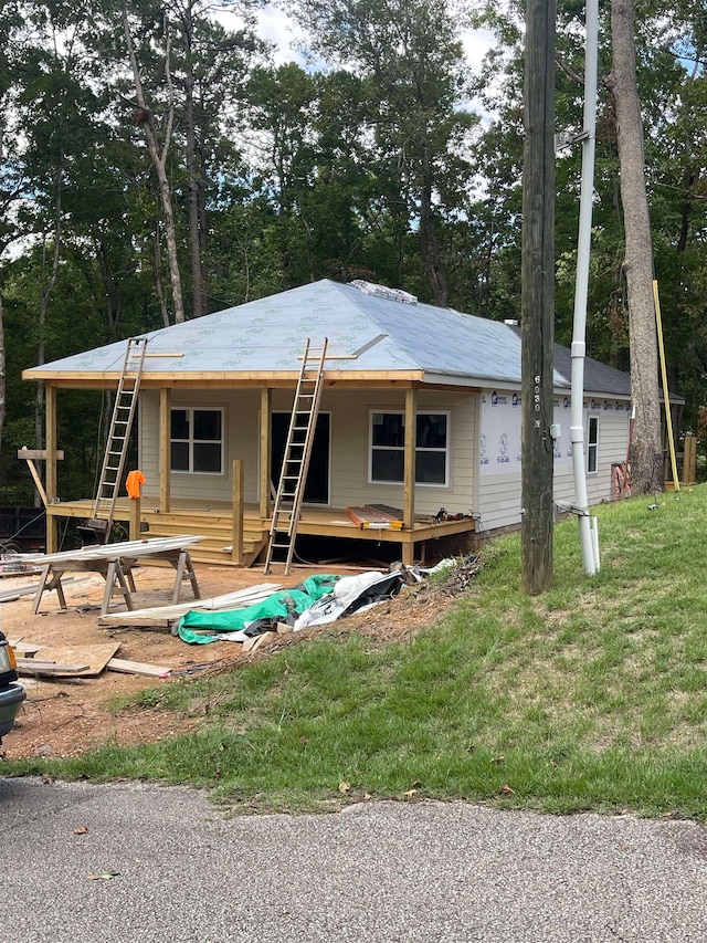 back of property featuring a lawn