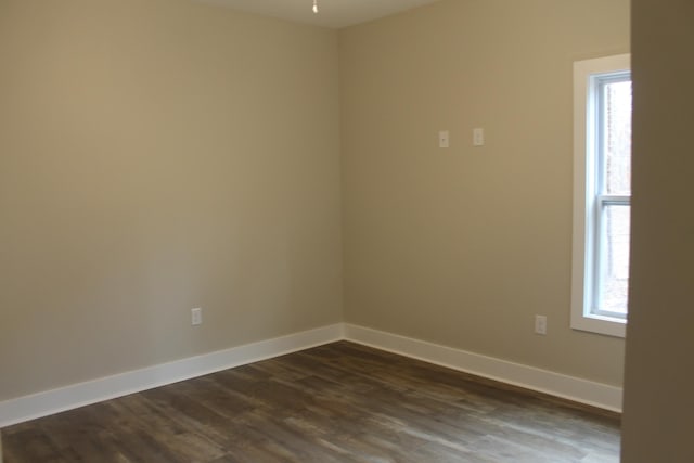 spare room featuring dark hardwood / wood-style floors