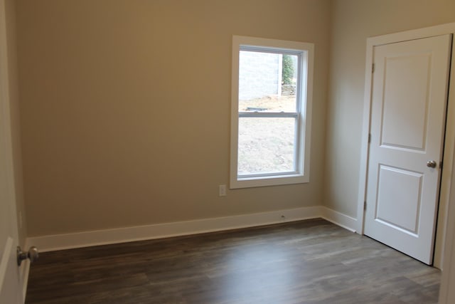 unfurnished room featuring dark wood-type flooring