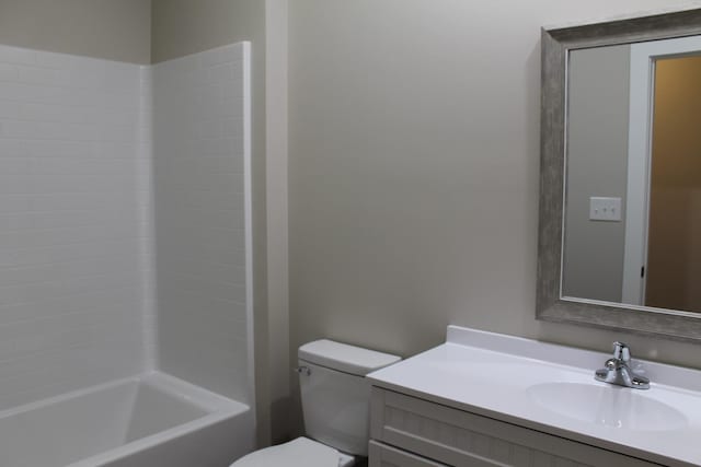 full bathroom featuring vanity, bathing tub / shower combination, and toilet