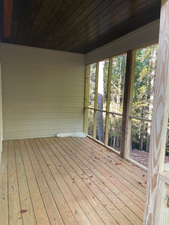 unfurnished sunroom with wooden ceiling