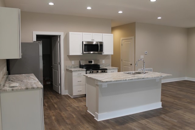 kitchen with sink, white cabinetry, an island with sink, stainless steel appliances, and light stone countertops