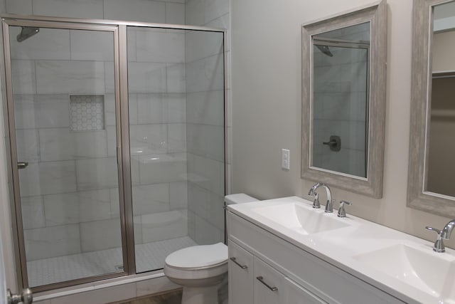 bathroom featuring vanity, toilet, and an enclosed shower