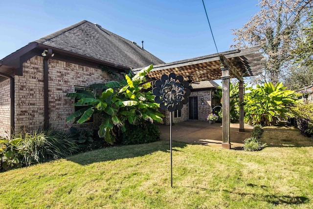 rear view of house featuring a patio and a lawn