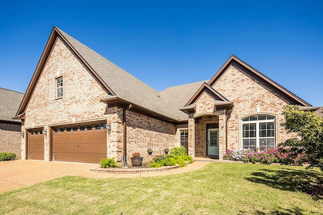 view of front facade with a front yard and a garage