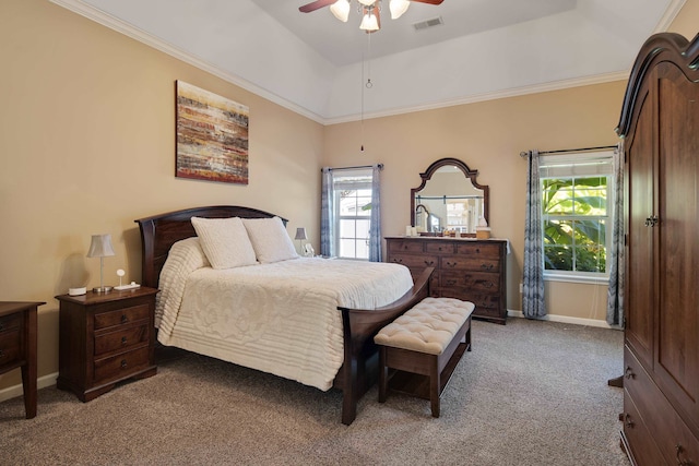 carpeted bedroom with a raised ceiling, crown molding, multiple windows, and ceiling fan