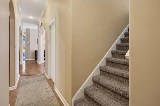 hall with hardwood / wood-style flooring and ornamental molding